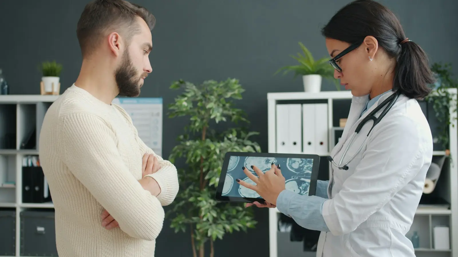 Doctor showing a patient a scan on a tablet